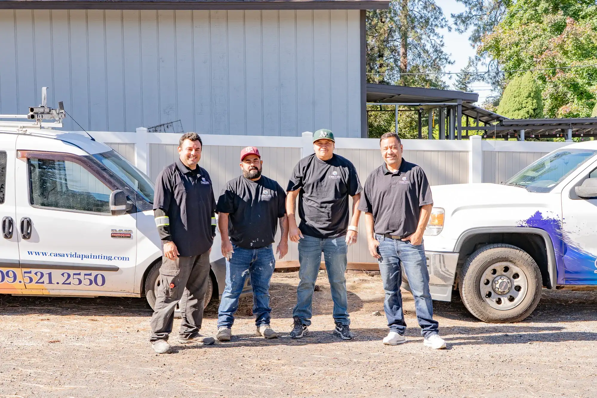 The Casa Vida crew with owner Victor on the right, standing between the company van and truck