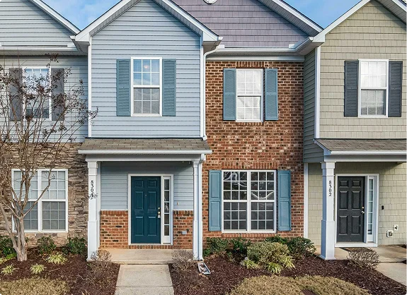 Row of modern townhouses with brick and siding exterior and front doors